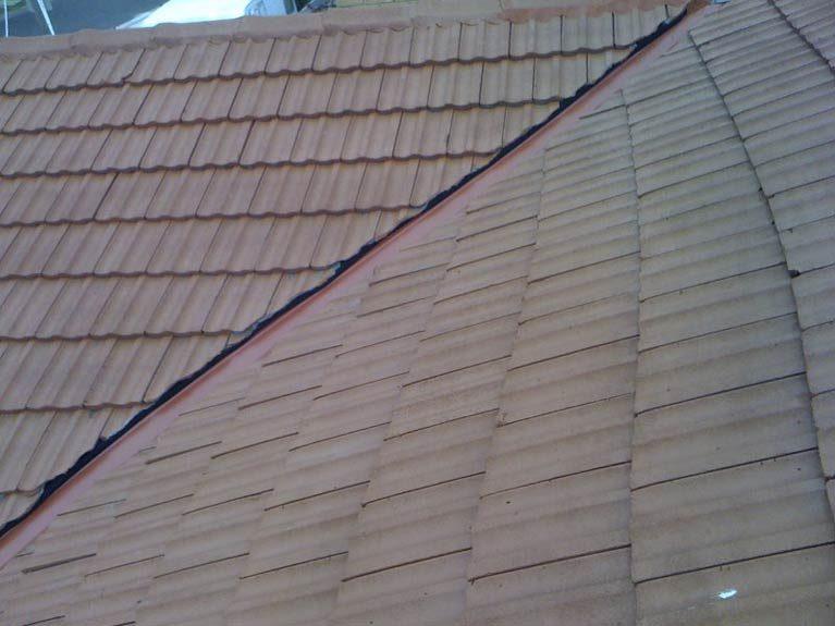 Restored tile roof with freshly re-pointed ridge and hip caps