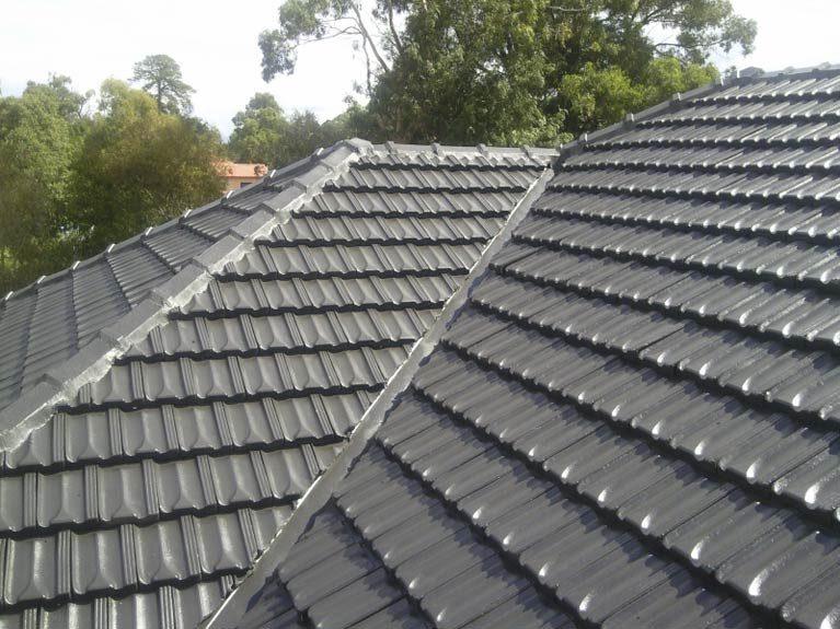 Restored charcoal tile roof with a newly replaced valley