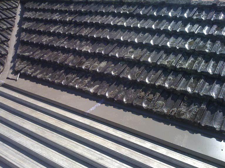 Tile roof part-way through a pressure clean