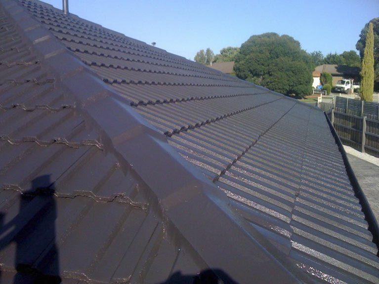 Grey tile roof after re-bedding, flexi pointing and re-colouring