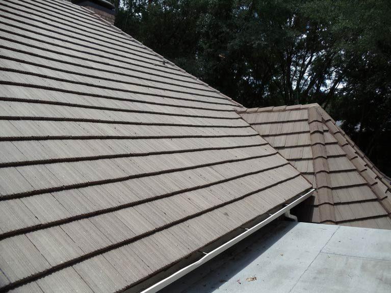 Tile roof with a newly replaced valley running to the gutter